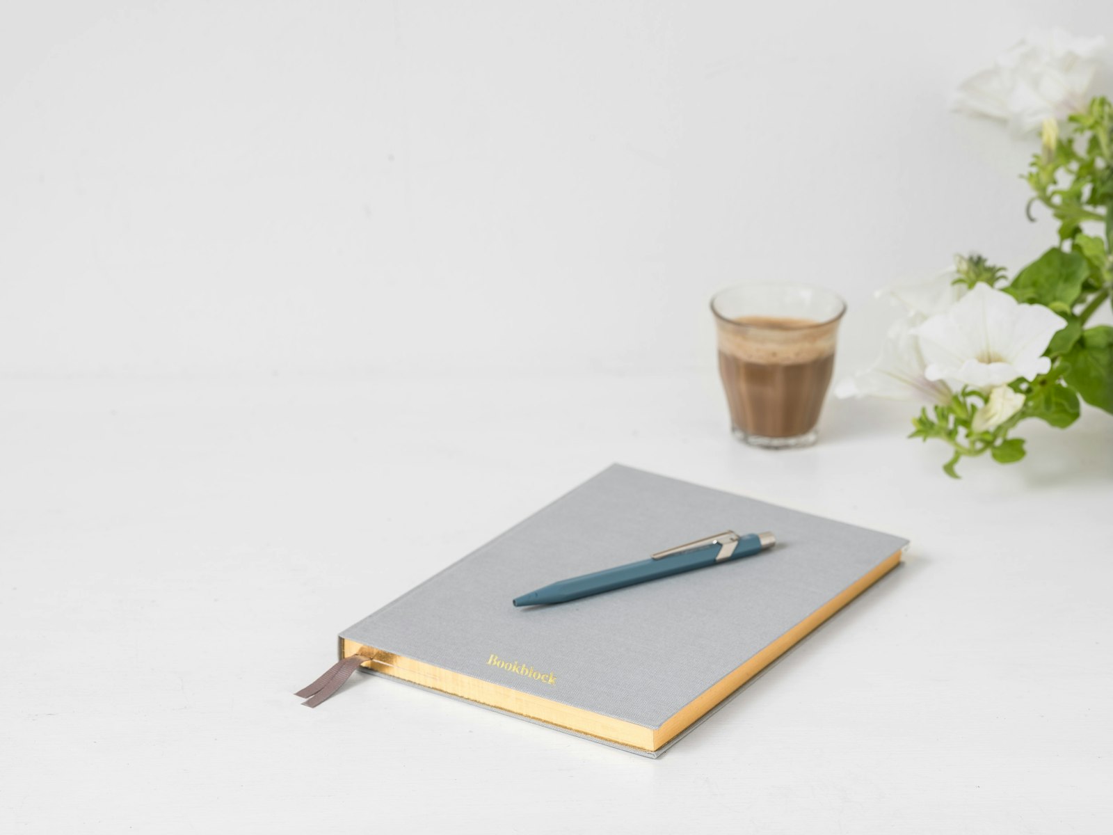 A notebook and pen on a bright, tidy table
