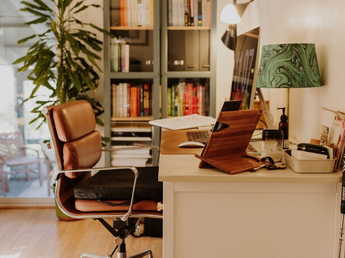 A quiet home office with a desk, chair and laptop