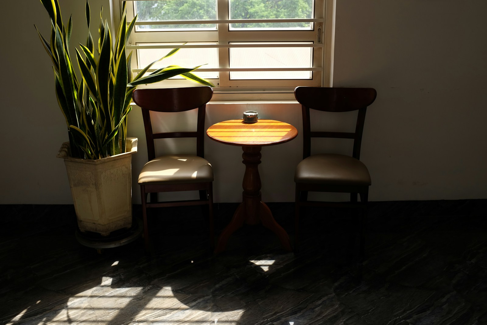 Soft light through a window onto an empty chair