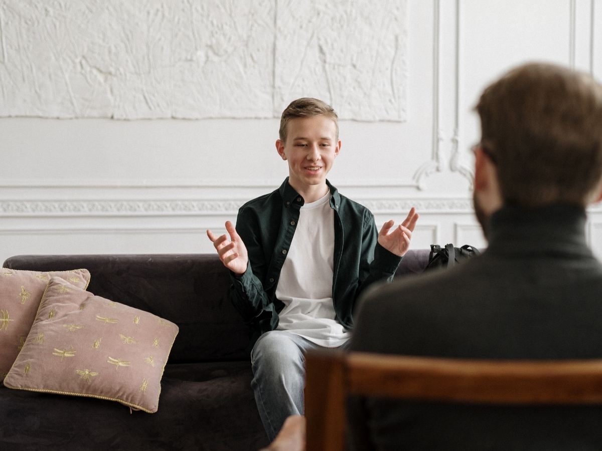 A teenager talking with a therapist during a session
