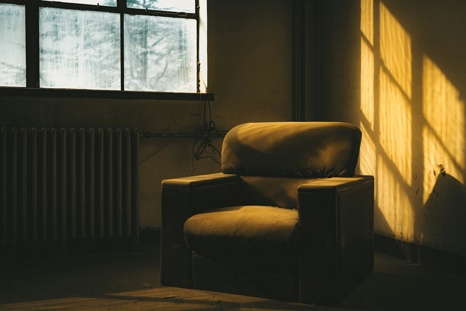An armchair in warm sunlight beside a window