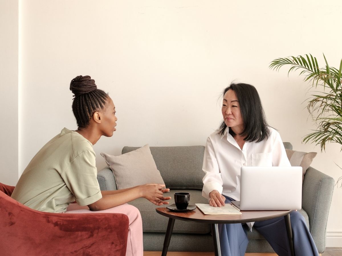 Two people in a calm, unhurried conversation on a sofa